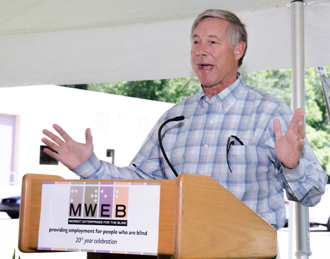 A picture of a man speaking at a podium.