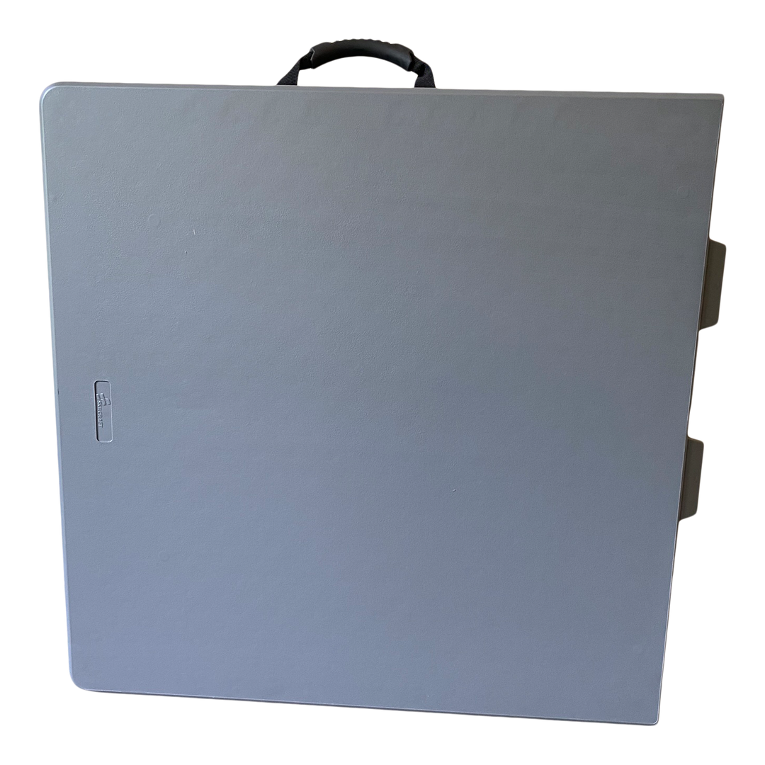 A closeup pictured of a folded charcoal bi-fold folding table.