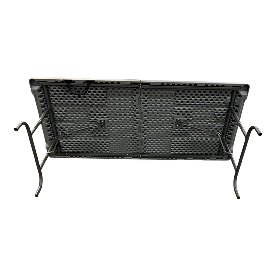 An underside view of a charcoal table laying on its side. 