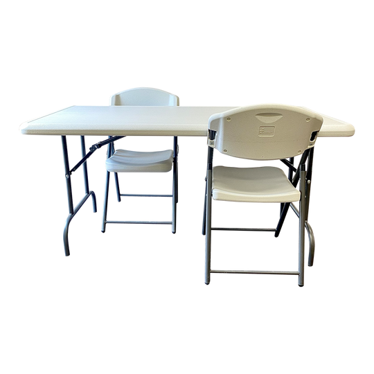A platinum table with one platinum chair in front of it and one platinum chair behind it. 