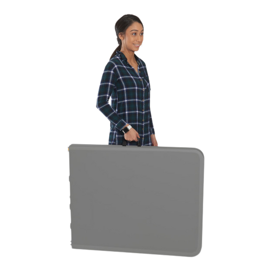 A person carrying a folded charcoal table. 